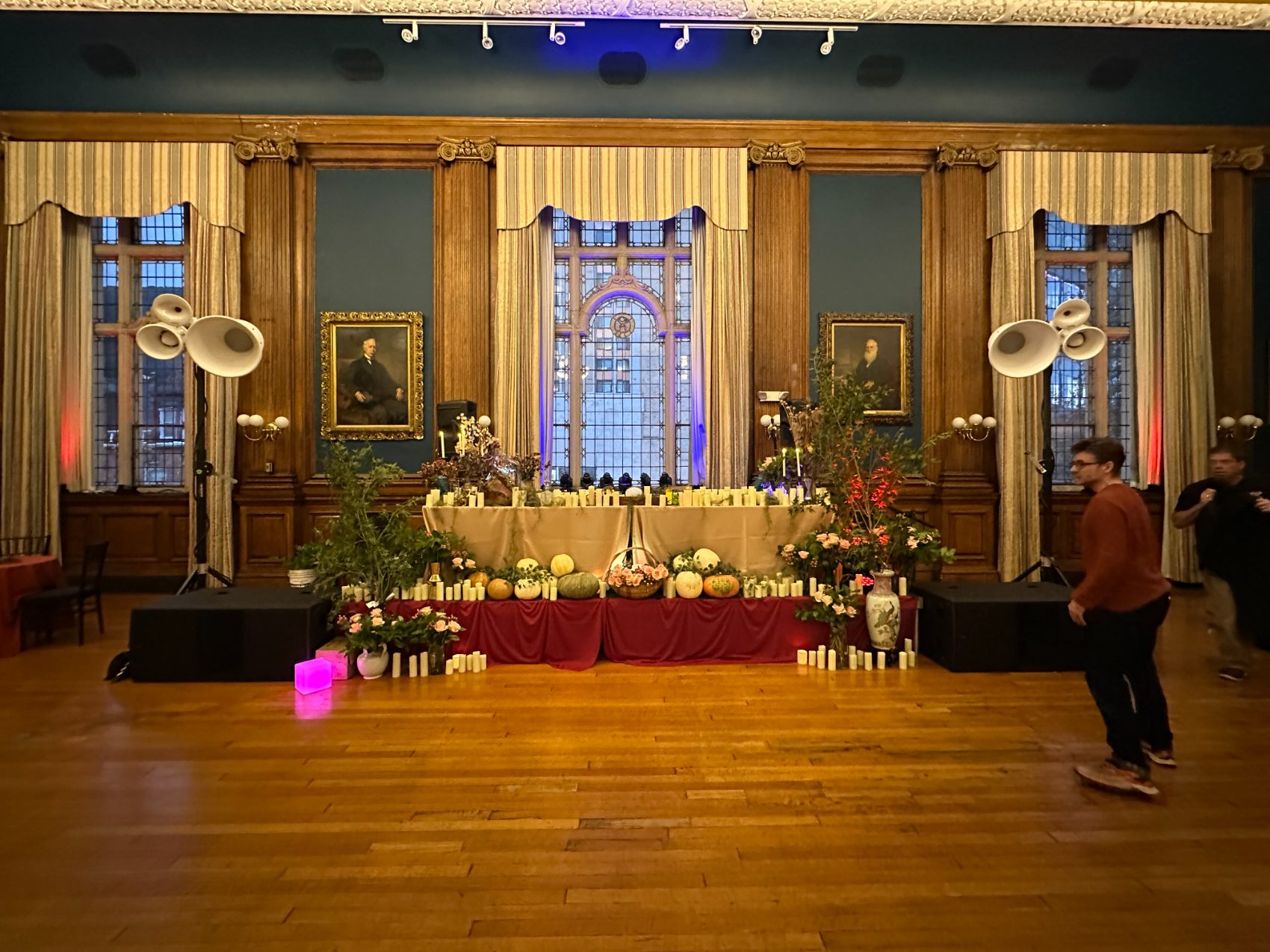 Void horn clusters flanking a candlelit stage
